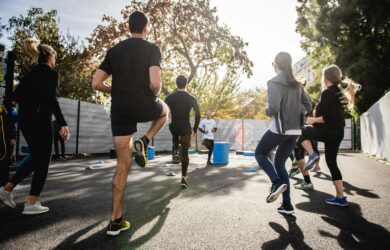 man in black t-shirt and black shorts running on road during daytime